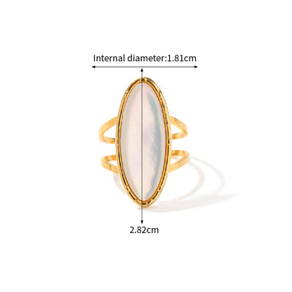 Gold ring with a white stone, showing measurements on a white background