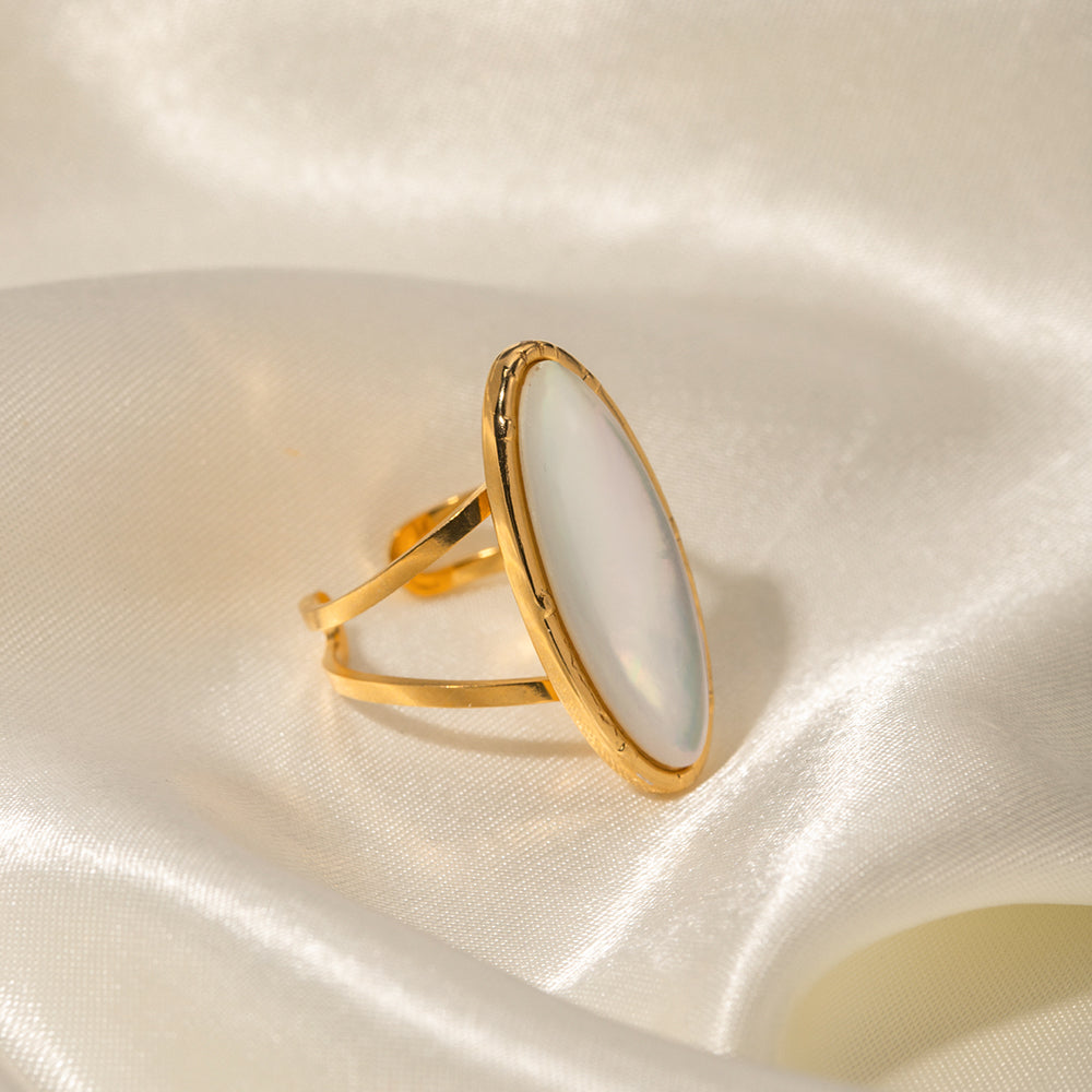 Gold ring on a soft, light-colored fabric background