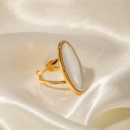 Gold ring on a soft, light-colored fabric background