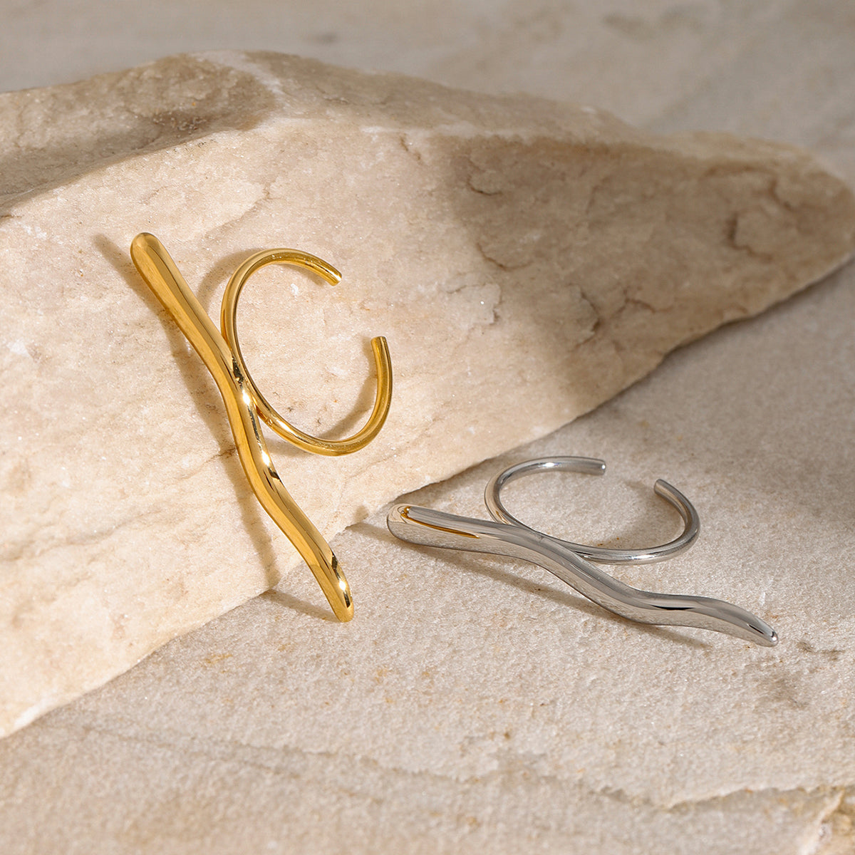 Gold and silver waterproof rings on a stone surface