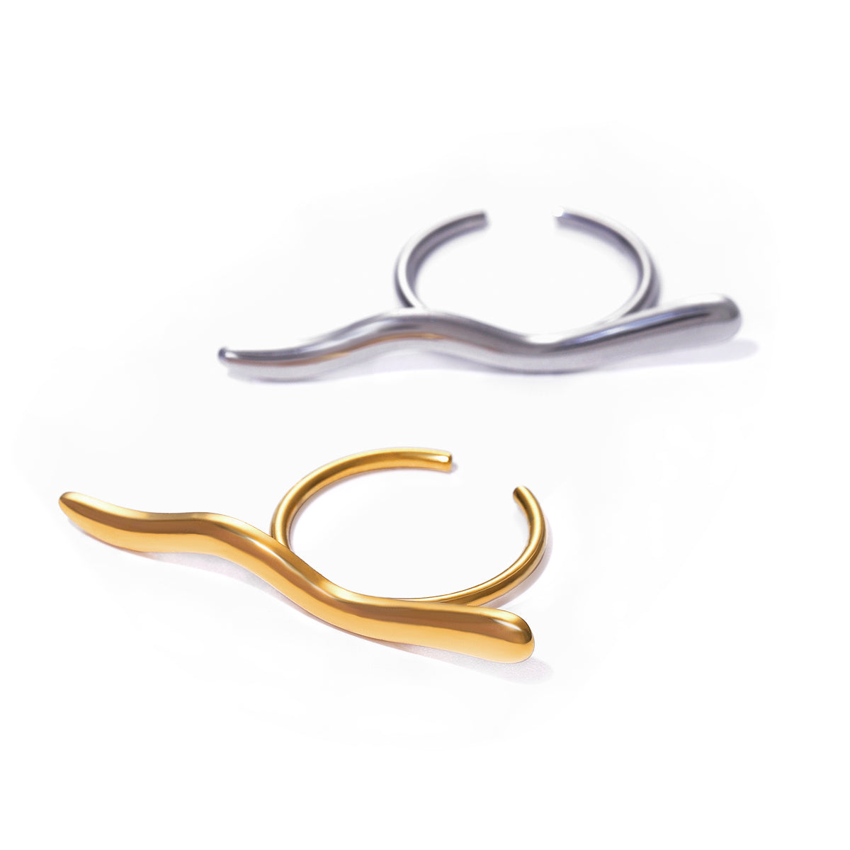 Gold and silver curved rings on a white background