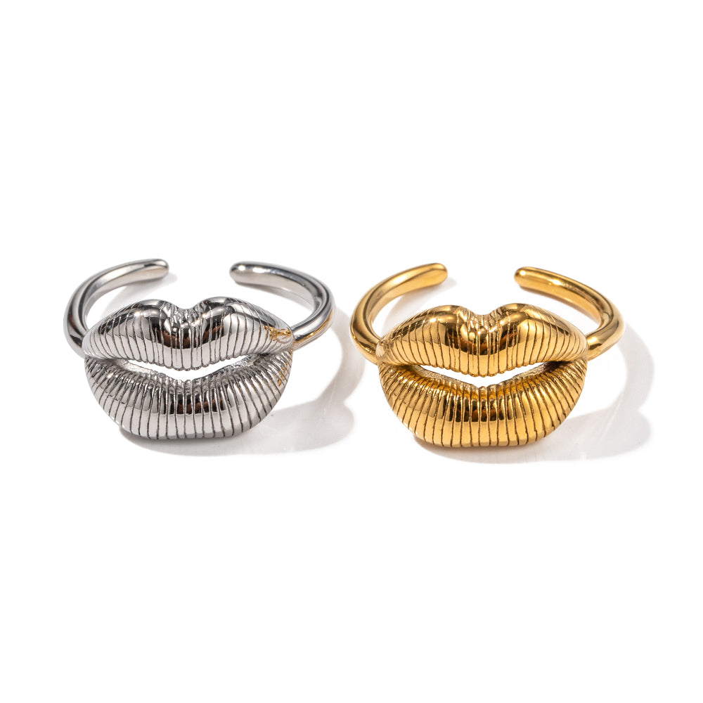 Gold and silver lip-shaped rings on a white background