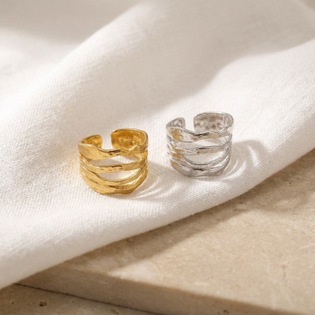 gold and silver waterproof rings on white fabric