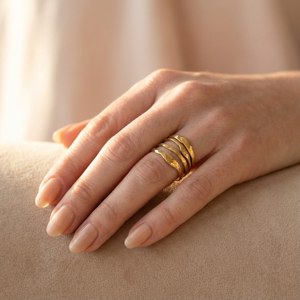 hand wearing a chunky ring in gold color