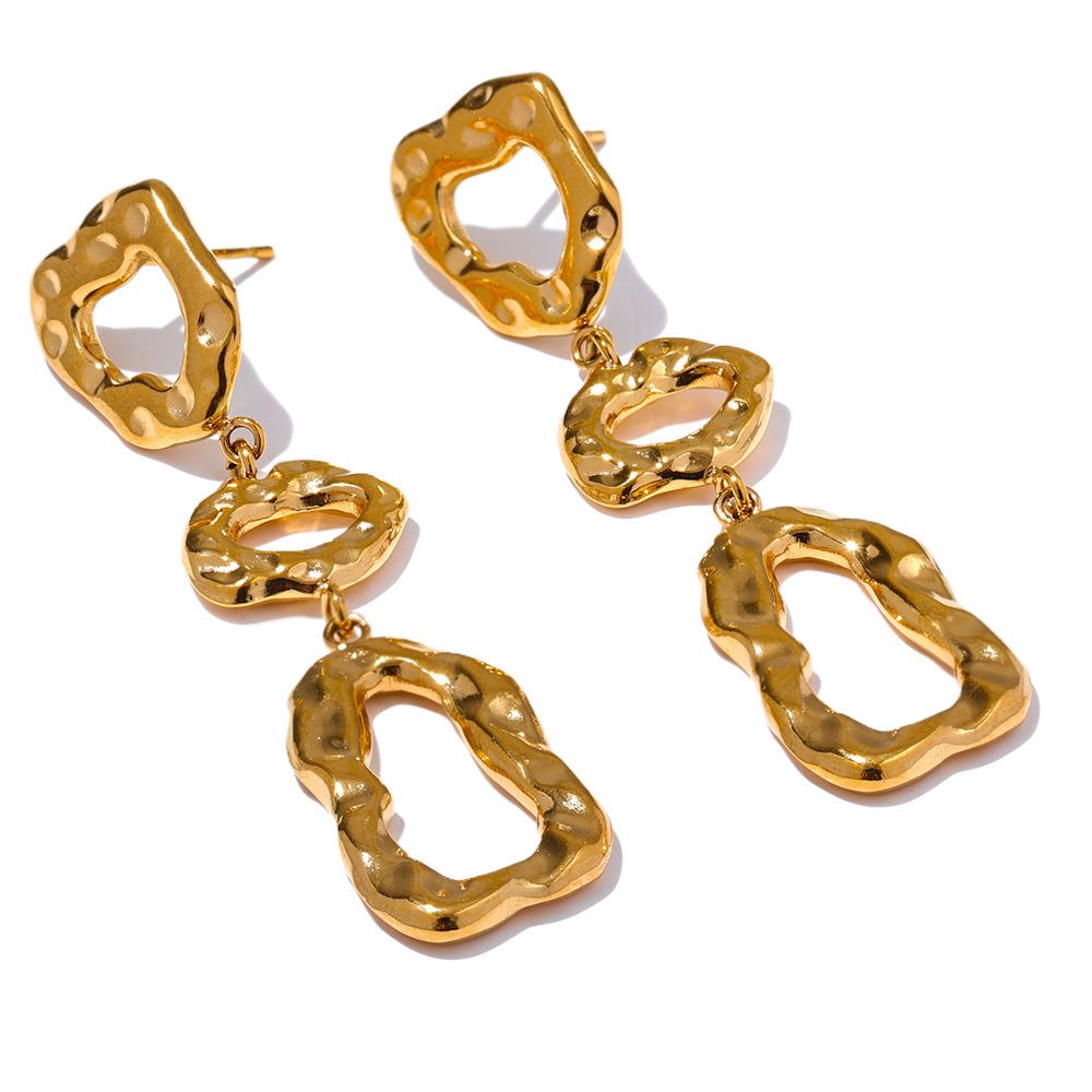 Gold statement earrings with textured design on a white background