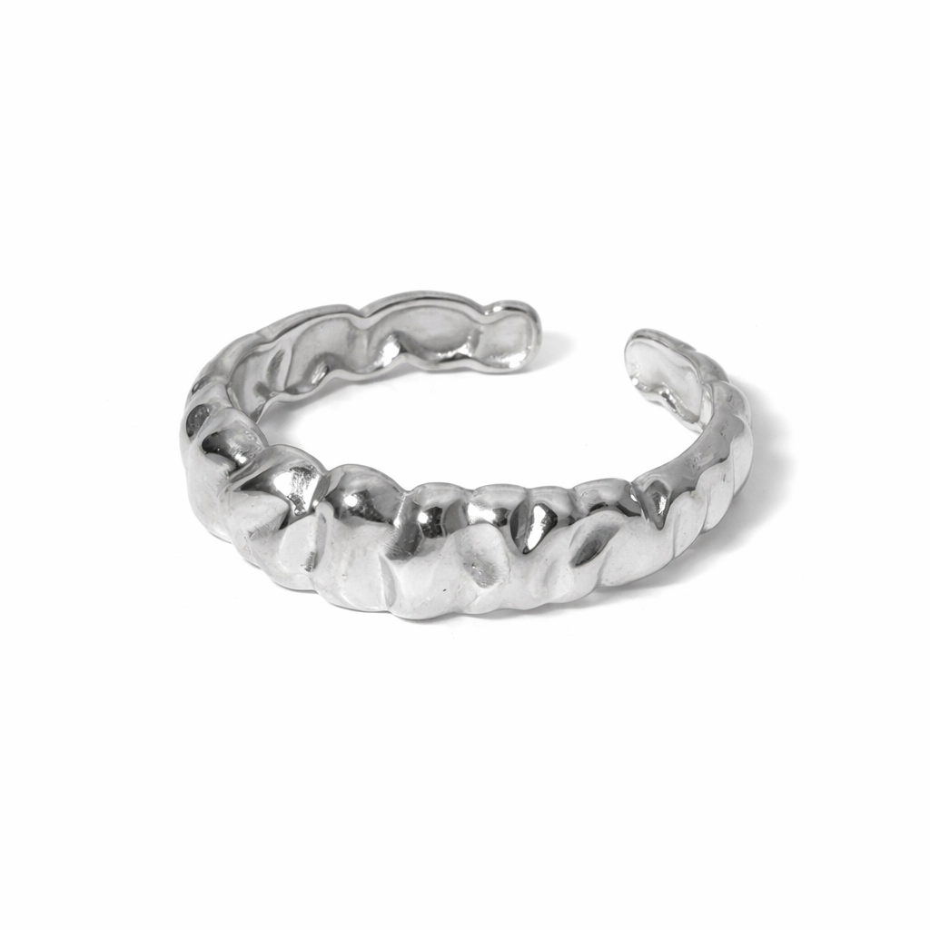 Silver ring with a textured band on a white background