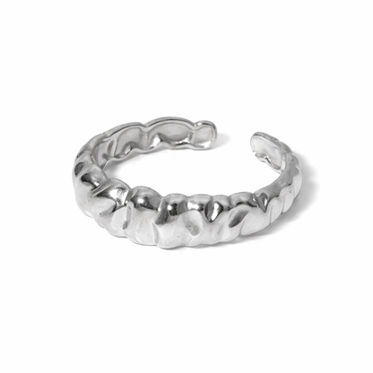 Silver ring with a textured band on a white background