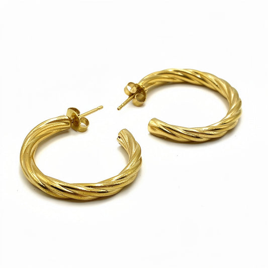 Gold hoop earrings on a white background