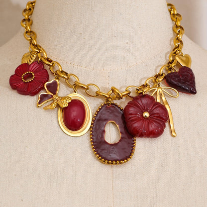 Gold and red floral necklace on a mannequin bust.