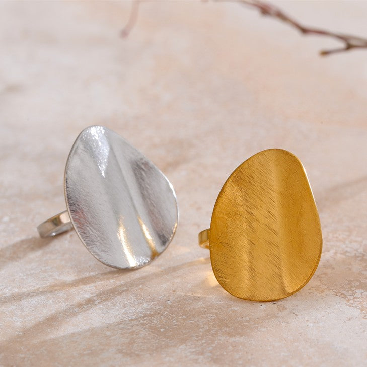 Gold and silver ring on a marble surface