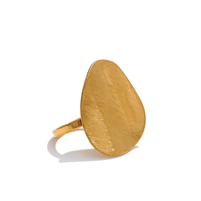 Gold ring with a textured oval design on a white background