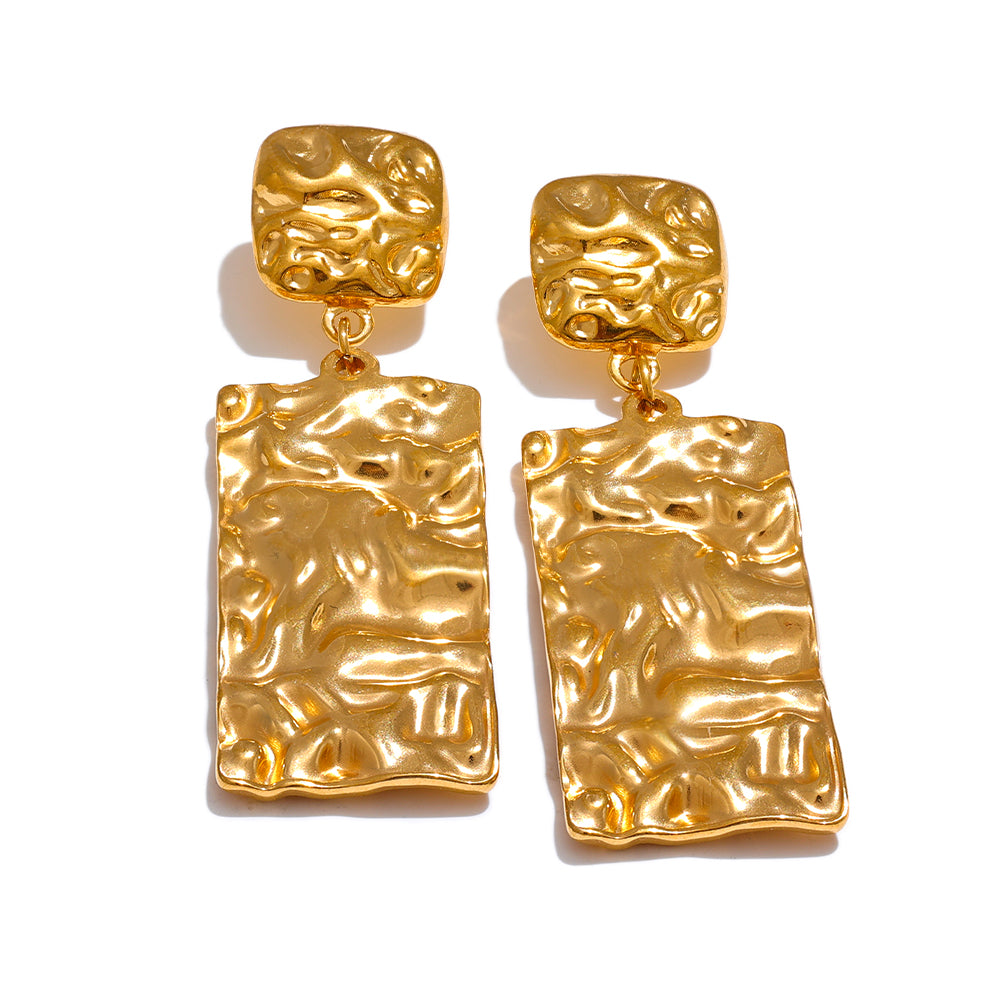 Pair of gold statement earrings with textured design on a white background