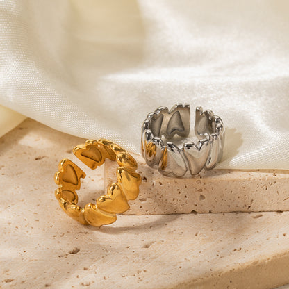 Gold and silver rings on a textured surface with a soft fabric background