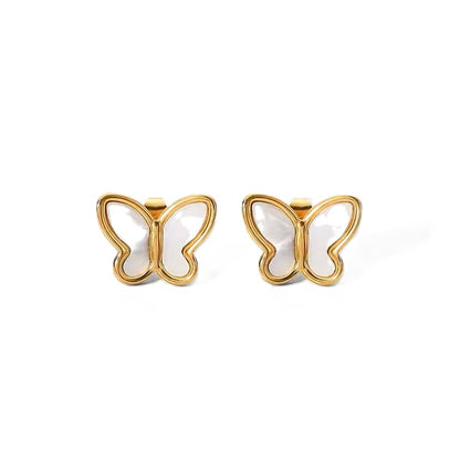 Butterfly-shaped earrings with gold frames and white centers on a white background