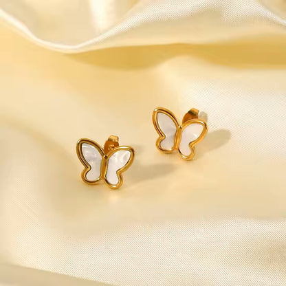Gold stainless steel butterfly earrings on a satin background