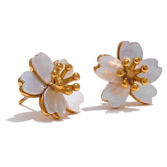 Pair of floral earrings with gold accents on a white background