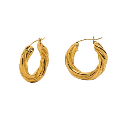 Gold hoop earrings on a white background
