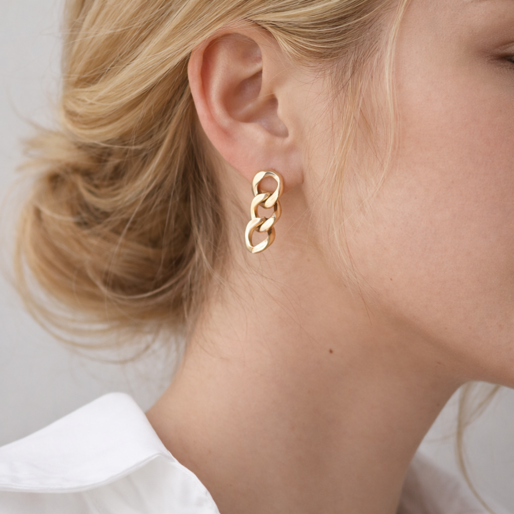 model wearing gold chain earrings