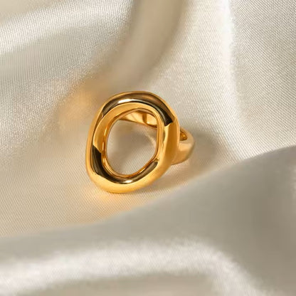 stainless steel Gold ring on a beige fabric background