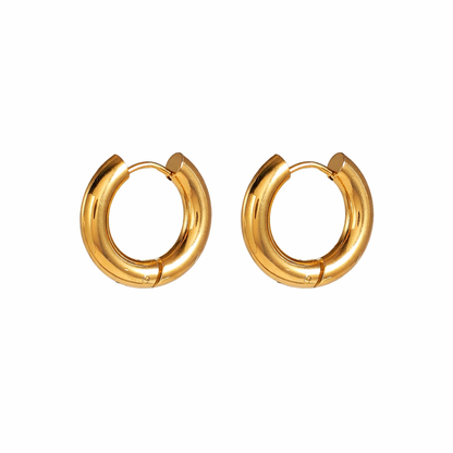 Pair of simple gold hoop earrings on a white background
