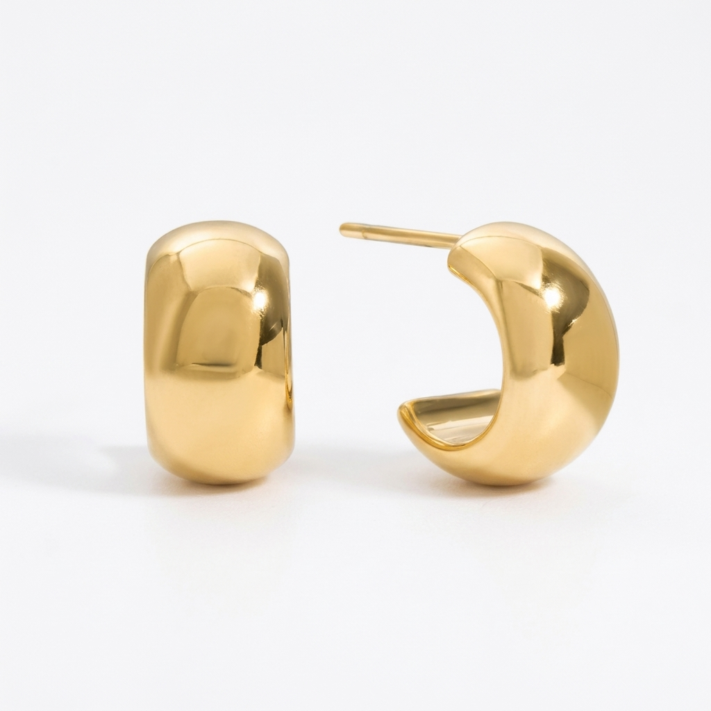 Small gold huggie hoop earrings in waterproof stainless steel, featuring a wide, rounded shape and polished finish, Pola Grace.