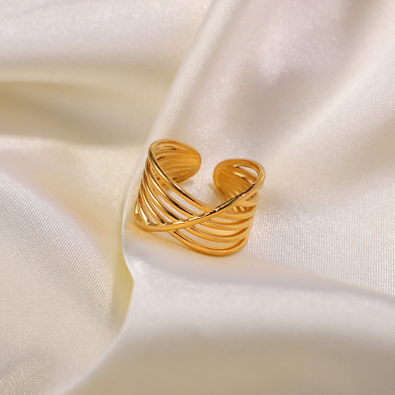 Gold open ring on a beige fabric background