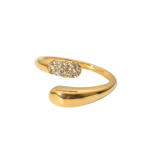 Gold open ring with gemstone detailing on a white background