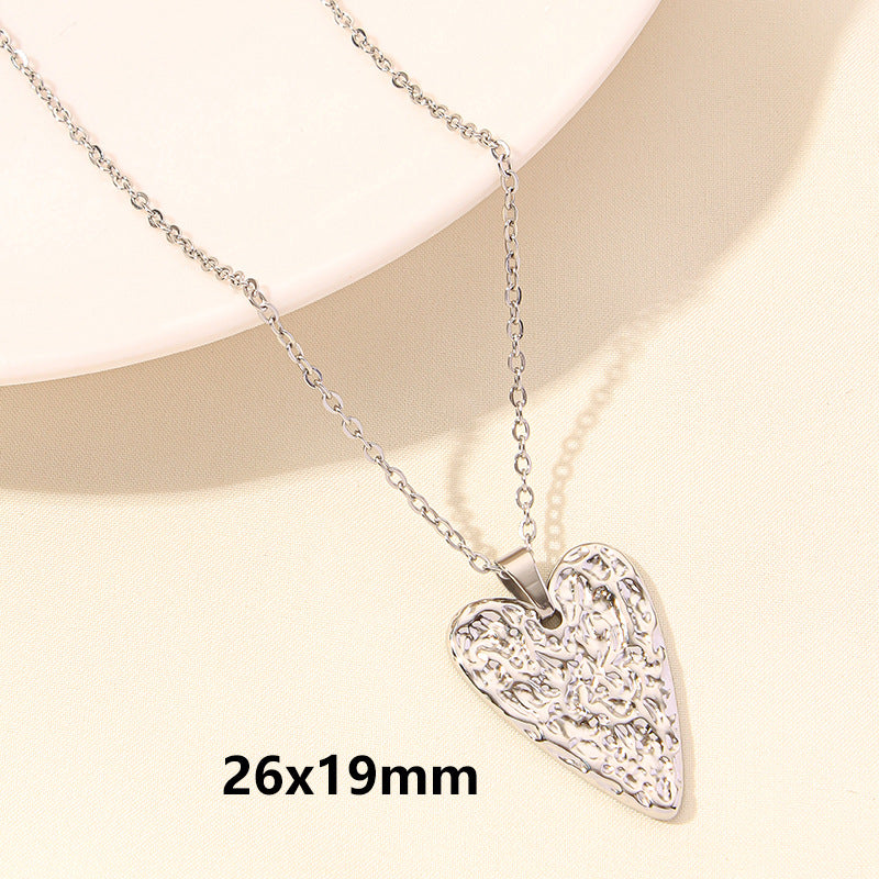 Silver heart-shaped pendant necklace on a beige background with dimensions 26x19mm.