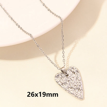 Silver heart-shaped pendant necklace on a beige background with dimensions 26x19mm.