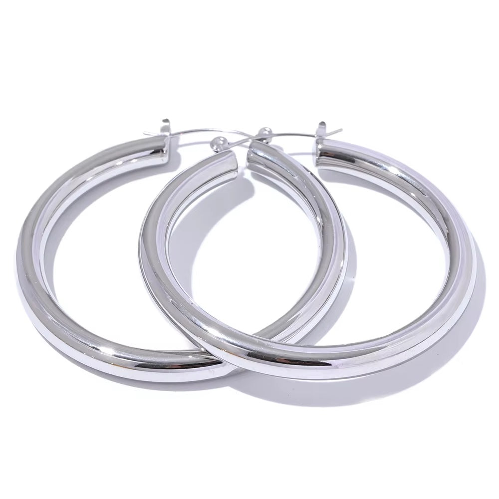 Pair of silver hoop earrings on a white background