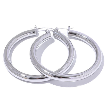 Pair of silver hoop earrings on a white background