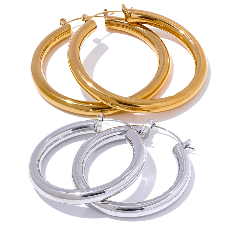 Gold and silver hoop earrings on a white background