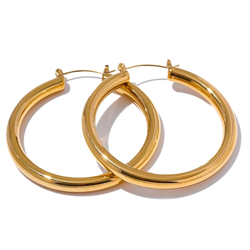 Pair of gold hoop earrings on a white background