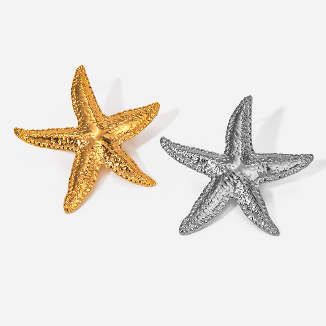 Gold and silver starfish on a white background