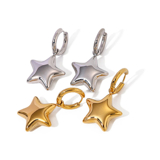 star-shaped earrings in silver and gold on a white background