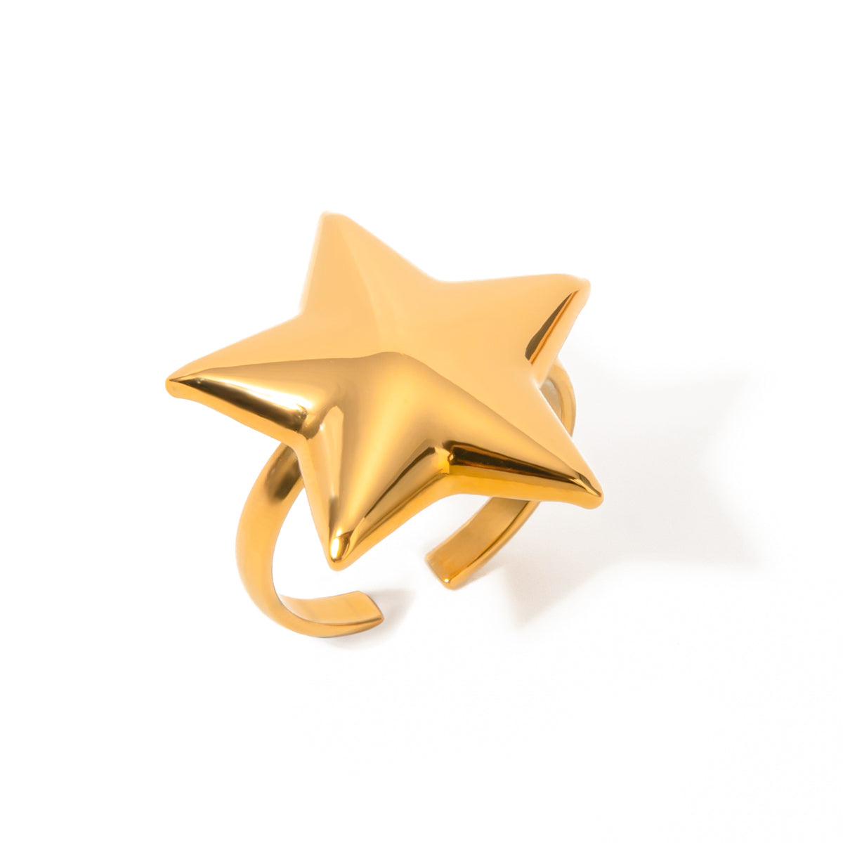 Gold star-shaped ring on a white background