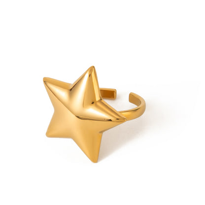 Gold star-shaped ring on a white background