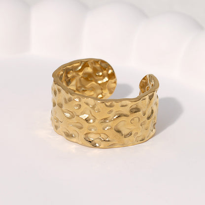 Gold textured ring on a white background