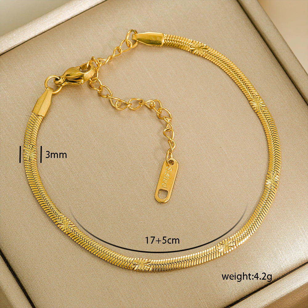 Gold stainless steel bracelet with measurements and weight details on a beige background