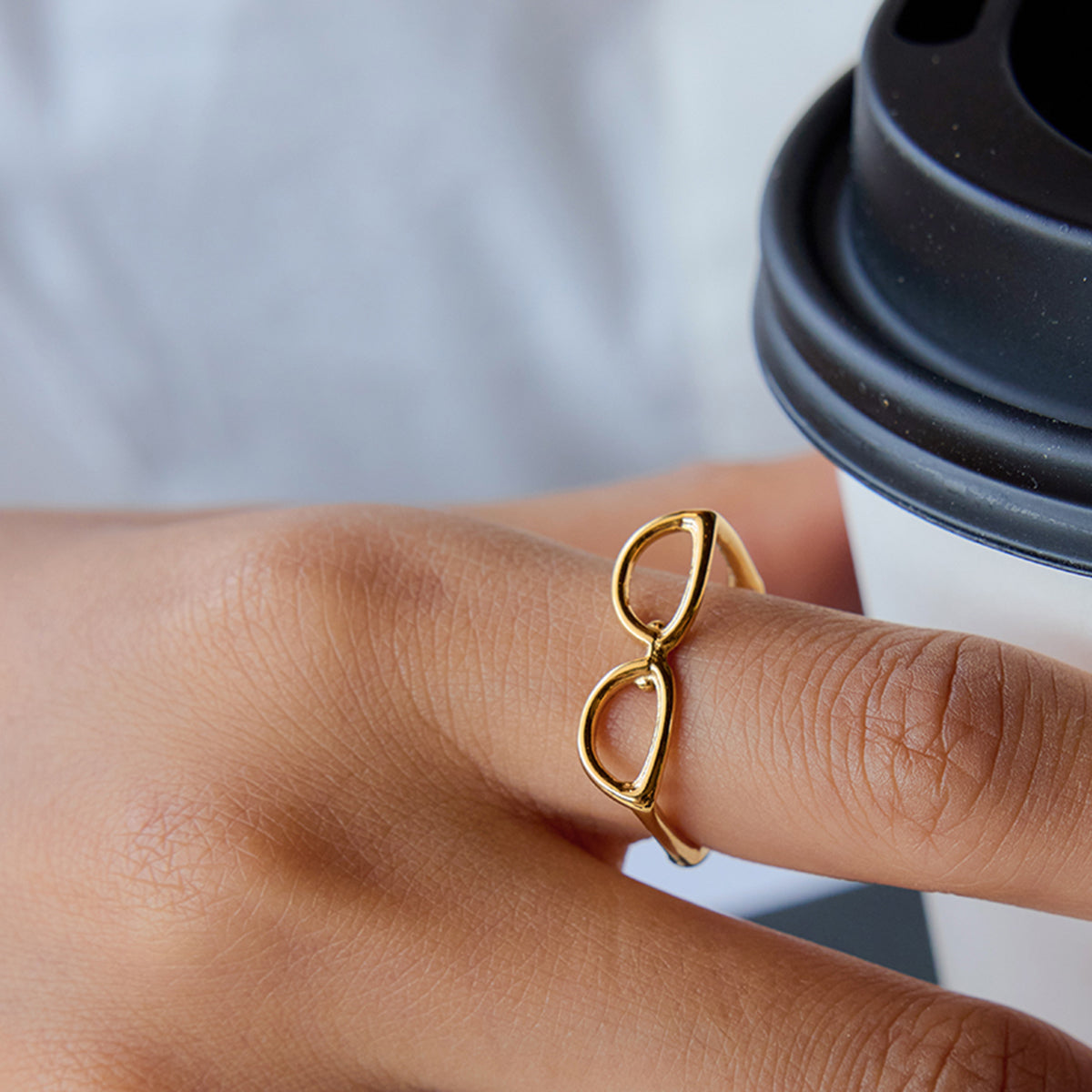 Gold ring on a finger with a blurred background