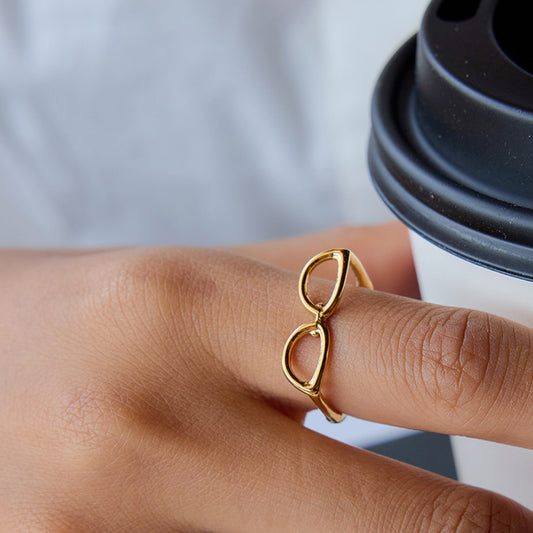 Gold ring on a finger with a blurred background