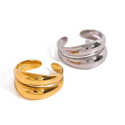 Gold and silver open rings on a white background