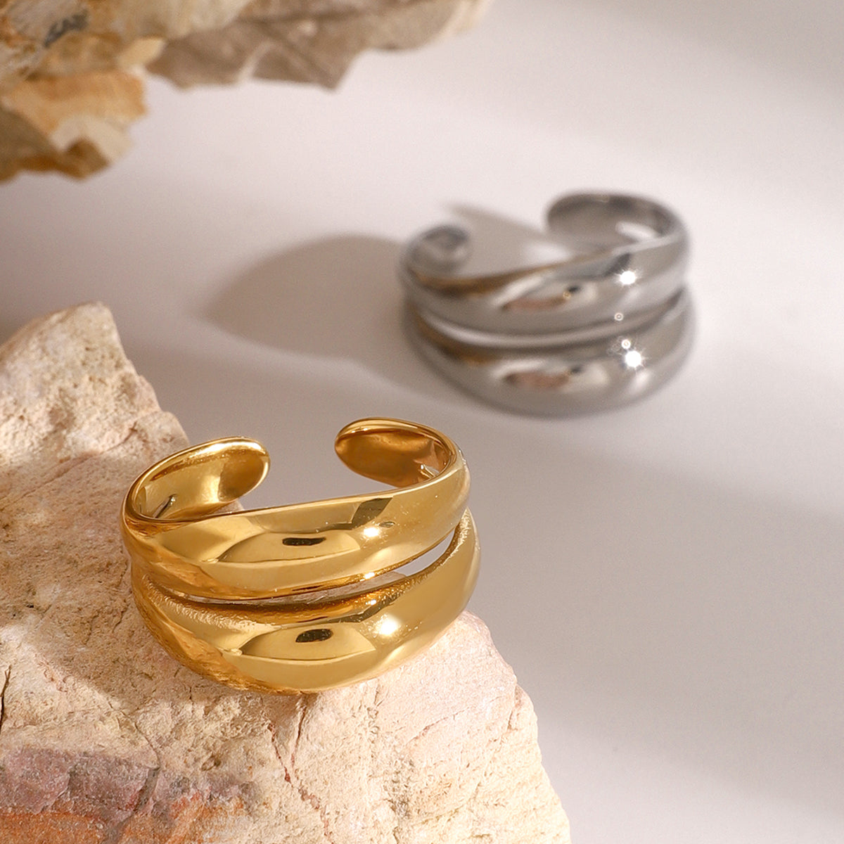 Gold and silver waterproof rings on a stone surface