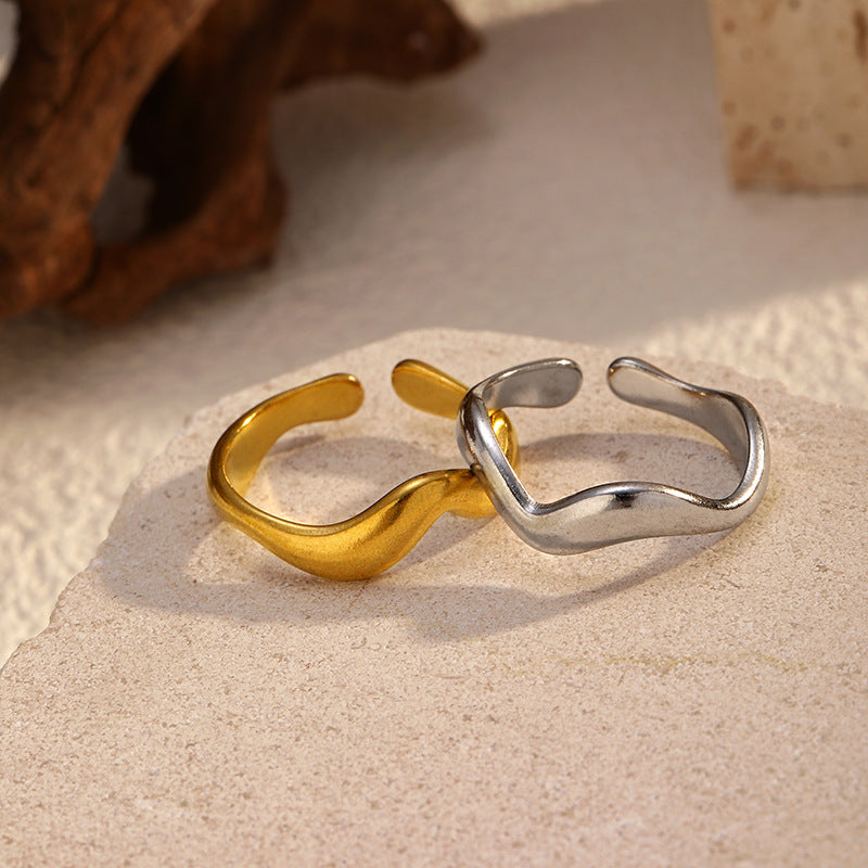 two stainless steel rings on a beige background