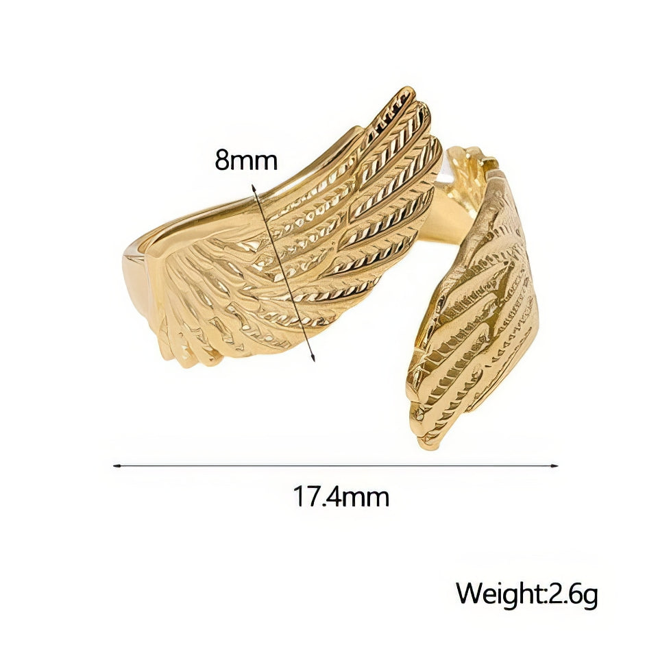 Gold wing-shaped ring with measurements and weight details on a white background